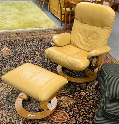 Lot 1174 - A tan leather reclining Stressless chair together with matching footstool