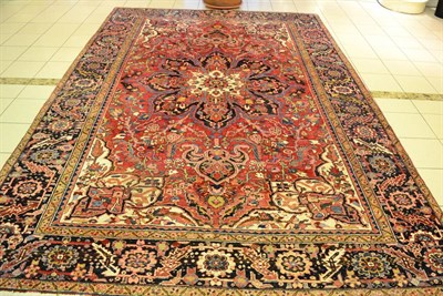 Lot 1175 - Heriz carpet, Persian Azerbaijan, the raspberry field centred by a flowerhead medallion framed...