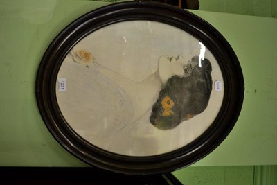 Lot 1231 - A pencil and watercolour picture of a pretty young woman in an oval  frame, signed J C Bell 1924