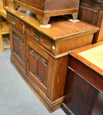 Lot 1283 - An Arts & Crafts oak dresser base, the drawers stamped with a registration number