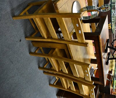 Lot 1284 - A modern light oak draw leaf dining table with six matching chairs together with a modern...