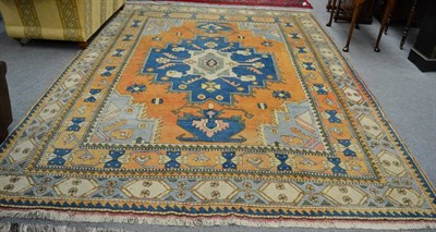 Lot 1334 - Kozak carpet, West Anatolia, The rust field centred by a mid indigo and ivory medallion, framed...