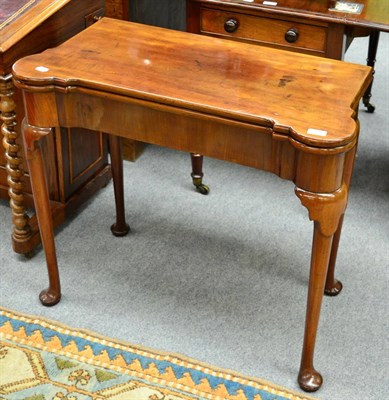 Lot 1336 - A Georgian mahogany fold-over games table on pad feet