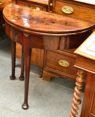 Lot 1338 - A Georgian mahogany fold-over table on pad feet