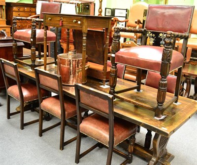 Lot 1366 - A large oak refectory table and a set of eight oak chairs with leather upholstery, labelled...