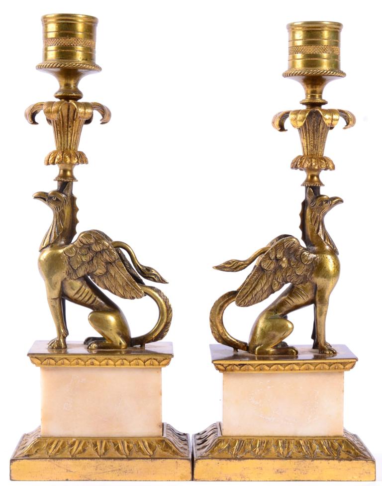 Lot 10 - A Pair of Gilt Metal and Marble Candlesticks, early 19th century, with drum sockets above leaf...