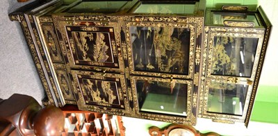 Lot 1385 - A Chinese ebonised glazed top cabinet with gilt decoration