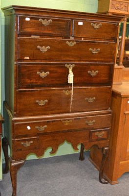 Lot 1390 - A Georgian oak chest on stand with mahogany inlay