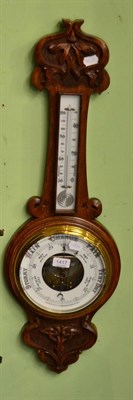 Lot 1417 - A carved oak aneroid barometer