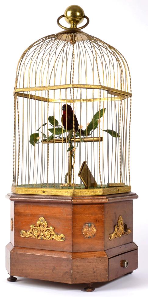 Lot 15 - A Coin Operated Singing Bird Automata, probably French, circa 1900, the bird with red plumage...