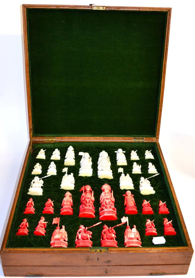 Lot 21 - A Chinese Export Stained and Natural Ivory Chess Set, circa 1900, of figural form, each piece...