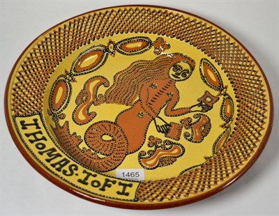 Lot 1465 - A modern Thomas Toft slipware dish decorated with a mermaid, 37.5cm diameter