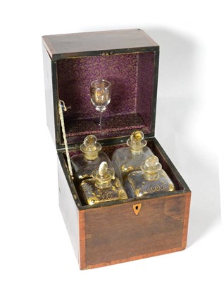 Lot 39 - A 19th century crossbanded mahogany four bottle decanter box, containing four gilt highlighted...