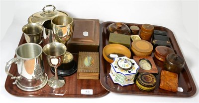 Lot 43 - Two trays consisting of 19th Century snuff boxes, Treen, French faience inkwell, silver trophy...