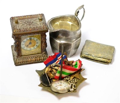 Lot 49 - A small carriage timepiece, lady's fob watch, silver cream jug, two medals, an Indian sword and...