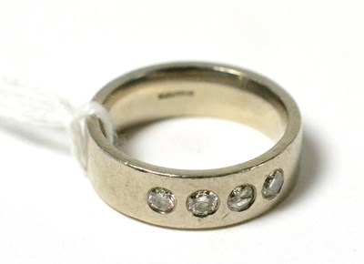 Lot 64 - A palladium four stone ring, stamped