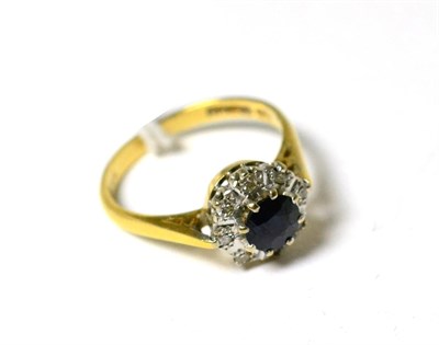 Lot 103 - An 18ct gold diamond and sapphire cluster ring