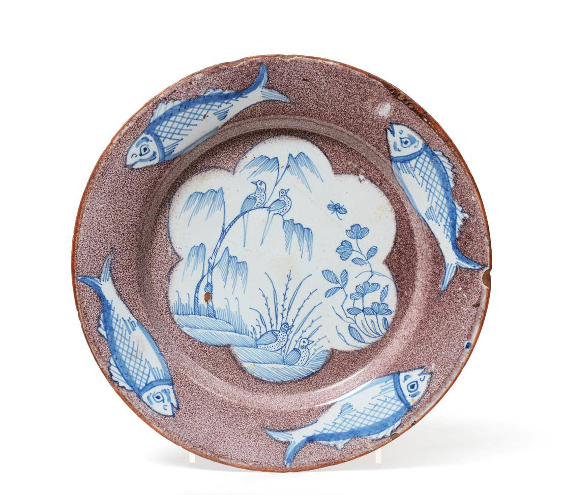 Lot 43 - An English Delft Plate, probably London, circa 1750, painted in blue with birds perched in branches