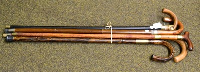 Lot 170 - Two umbrella walking sticks, two similar bamboo swordsticks and another with T shape handle (5)