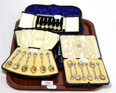 Lot 194 - A cased set of twelve silver tea spoons and a pair of sugar tongs, and three sets of six silver and