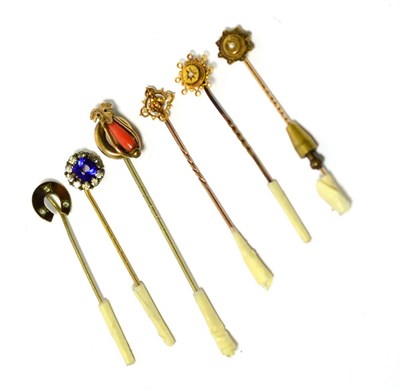 Lot 223 - Two 15ct gold stick pins, coral stick pin and three others