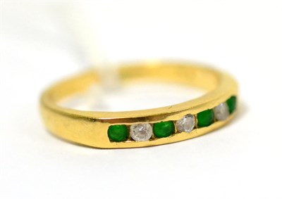 Lot 225 - An 18ct gold emerald and diamond ring