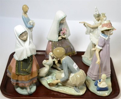 Lot 318 - Six Lladro figures, girl holding roses, girls holding a lamb, lady with geese, lady with head...