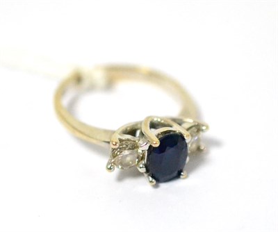 Lot 357 - An 18ct white gold sapphire and diamond three stone ring