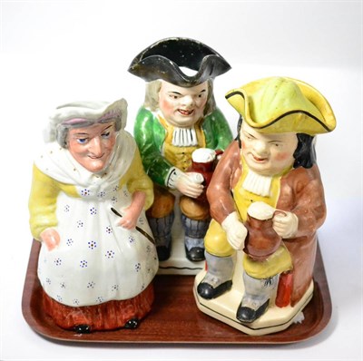 Lot 405 - Three toby jugs, two modeled as gentlemen, the other as a woman