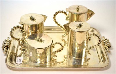 Lot 411 - A white metal five piece tea service comprising tray, teapot, hotwater jug, sugar bowl and...