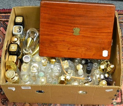 Lot 1032 - A collection of late 20th century perfume bottles, together with a mahogany cased silver plated...