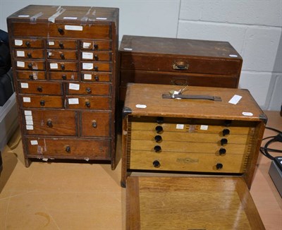 Lot 1087 - Three watchmakers cabinets containing a large quantity of pocket watch movements, drill bits, and a