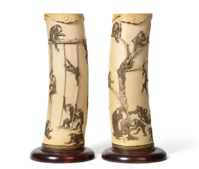 Lot 90 - A Pair of Japanese Ivory Tusk Vases, Meiji period, carved and stained with monkeys climbing on...