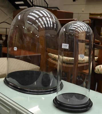 Lot 1099 - Two Victorian glass domes with bases (2)