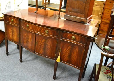 Lot 1130 - A reproduction dining table with matching bow fronted sideboard