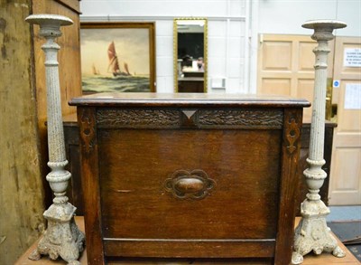 Lot 1152 - A pair of cast iron pricket sticks together with a small oak cabinet (3)