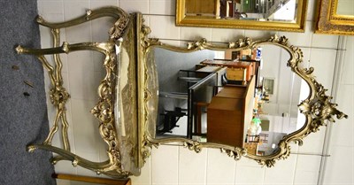 Lot 1163 - A silvered composition over mantel mirror in the Rococo taste with matching marble topped...