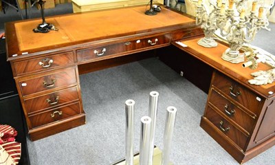 Lot 1169 - A substantial reproduction leather inset corner desk