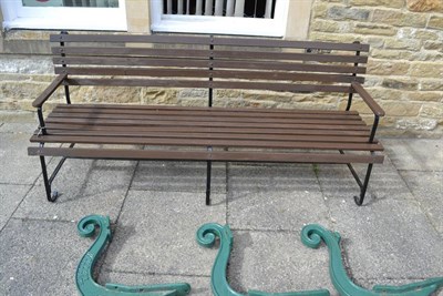 Lot 1182 - A metal garden bench with wooden slats