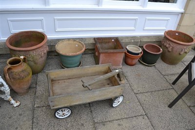 Lot 1184 - Assortment of terracotta and pottery planters, a Grecian style twin-handle urn and a dog cart