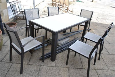 Lot 1185 - Modern glass topped and metal based garden table with six chairs, together with parasol (canvas...