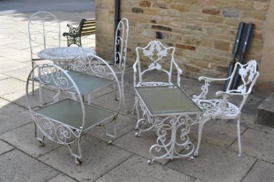 Lot 1187 - White painted metal garden furniture, comprising a pair of armchairs, a pair of chairs,...