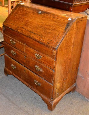 Lot 1272 - An early 19th century oak bureau