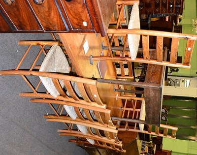 Lot 1273 - A pine farmhouse kitchen table and ten reproduction rush seated ladder back chairs