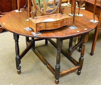 Lot 1284 - An 18th century oak gateleg table, raised on turned supports, the top heavily re-polished; together