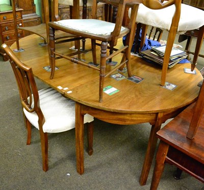 Lot 1296 - A late Georgian mahogany D-end dining table with fly legs, additional leaf and brass clips,...