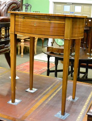 Lot 1302 - A mahogany reproduction occasional table with shaped top, a slide over a drawer, with key