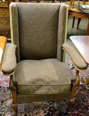 Lot 1310 - A Georgian style oak wingback armchair