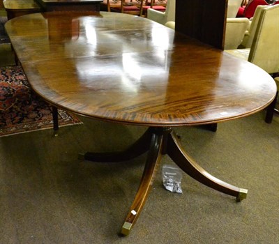 Lot 1313 - A large reproduction twin pedestal dining table with two leaves