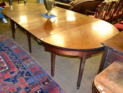 Lot 1315 - A George III mahogany D-end dining table, in three sections with two leaves and clips